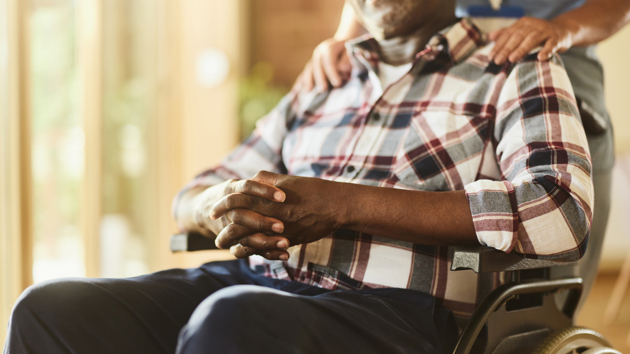 Unrecognizable disabled black man at retirement home.
